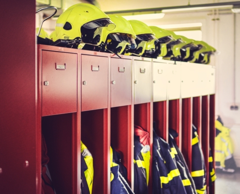 a row of lockers with helmets on top of them